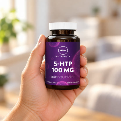 MRM Nutrition 5-HTP 100 mg held in an adult hand to show its size