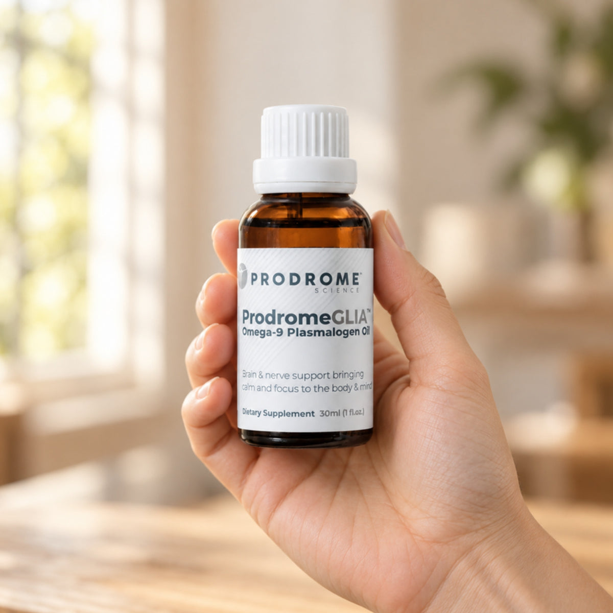 ProdromeGlia Oil 30 mL by Prodrome Sciences held in an adult hand to show its size