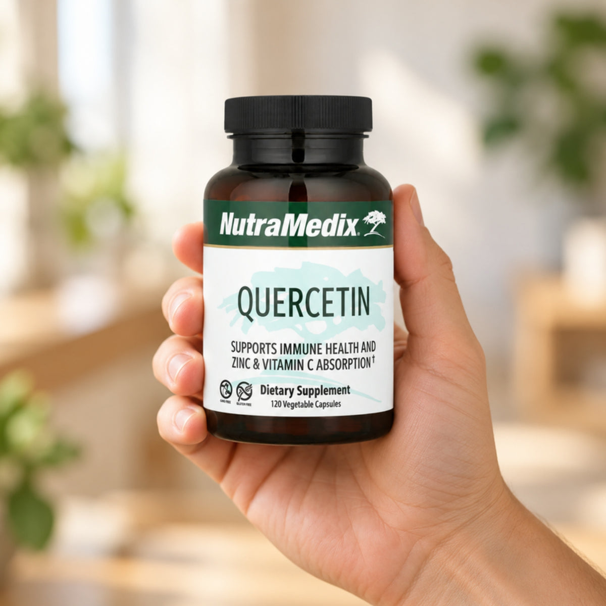 NutraMedix Quercetin 500 mg held in an adult hand to show its size